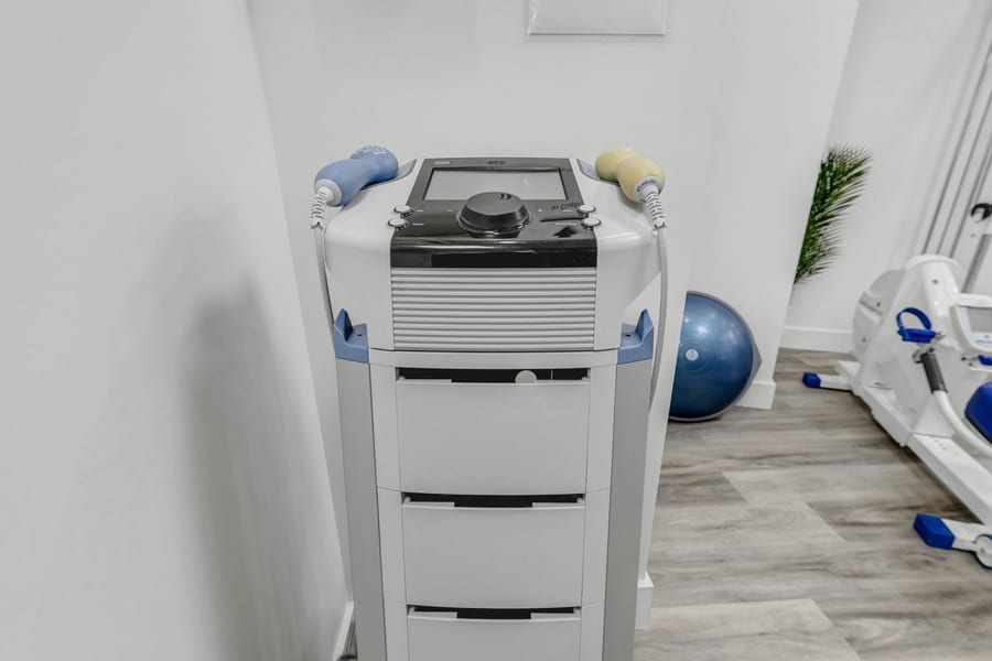 A therapy unit on its stand beside the clinic's exercise area