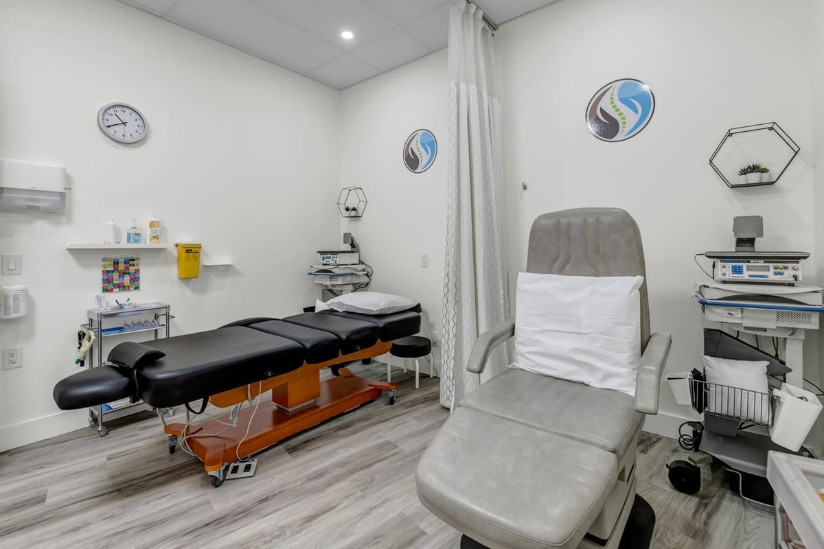 The chiropractic room at the clinic, with a drop table and a treatment chair