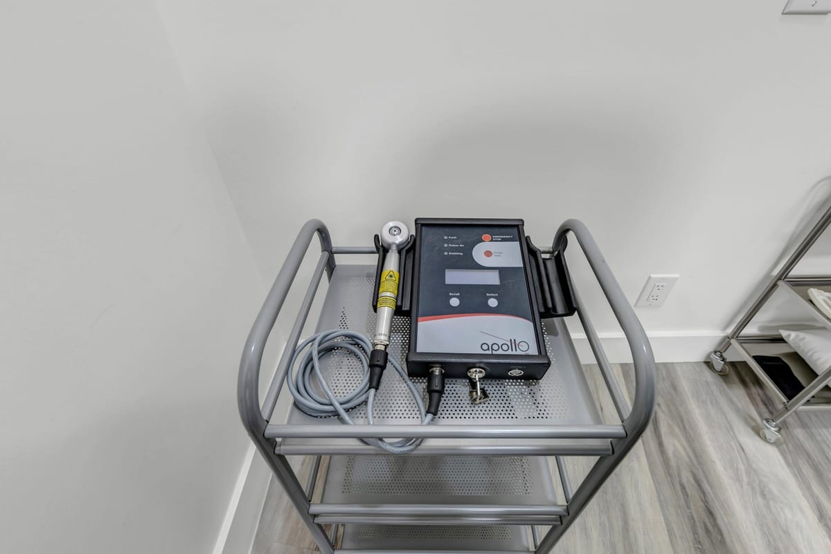 The clinic's Apollo laser unit on a trolley in a treatment room