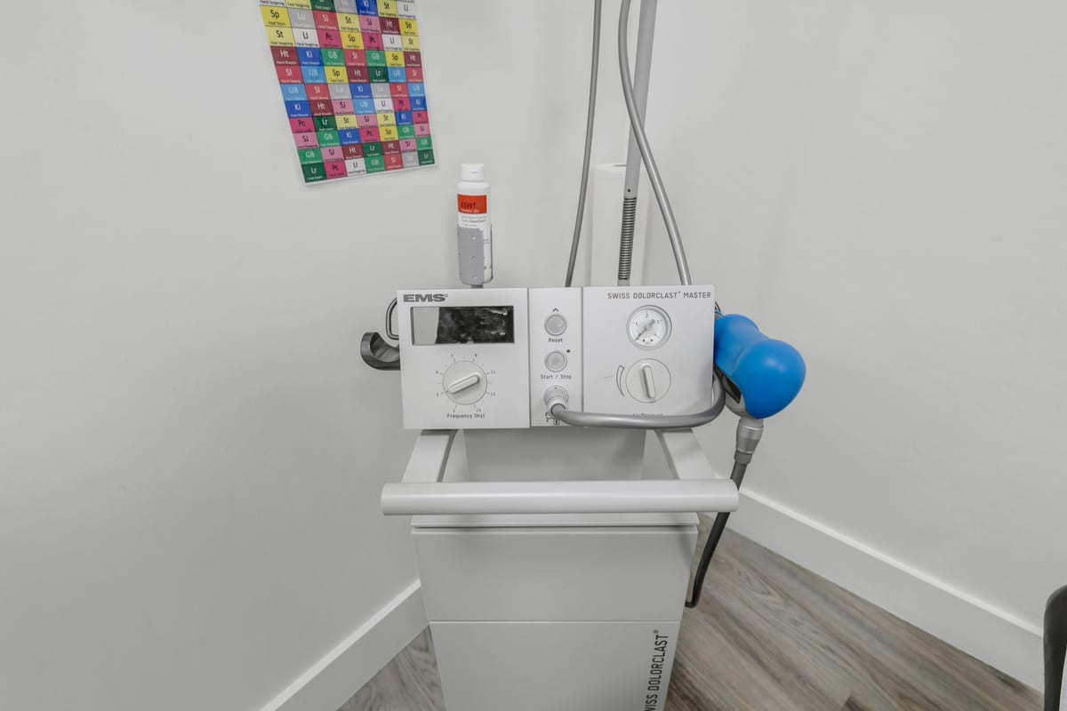 The clinic's Swiss DolorClast shockwave unit on its stand in a treatment room